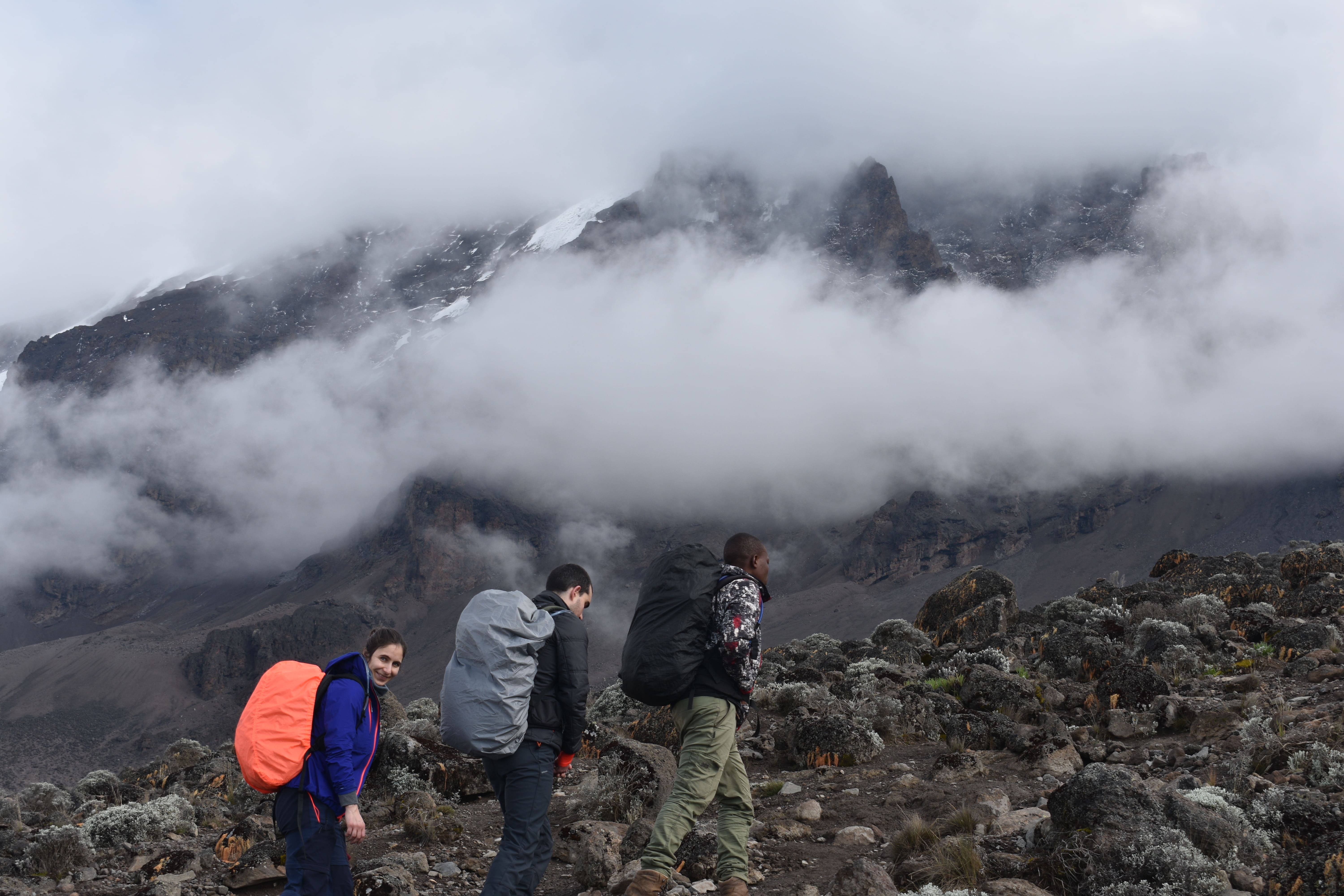 The Kilele Clan team celebrating on a mountain peak